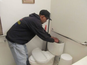 eden-maintenance-staff-installing-dual-flush-converters-victoria-green